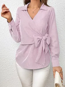 Detailed view of pink vertical striped long sleeve blouse with wrap front and bow