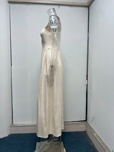 Detailed side view of a cream sleeveless high waist maxi dress featuring a side slit