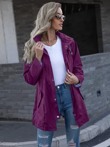 Model wearing a purple hooded zip-up raincoat for women in an outdoor urban setting