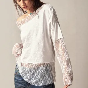 Close-up of white bohemian off-shoulder t-shirt featuring intricate floral lace sleeves