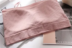 Macro view of soft pink ribbed seamless bandeau top showing fine fabric texture details