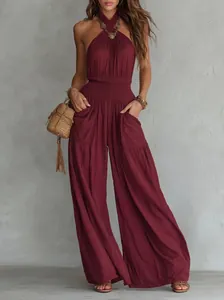 Detail view of the bohemian backless sleeveless wide-leg jumpsuit with waist smocking