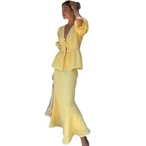 Elegant yellow two-piece set with puff sleeve V-neck tie top and high-waisted maxi skirt