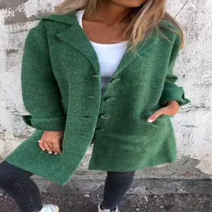 Detailed close-up of a green textured longline cardigan coat featuring buttons and pockets