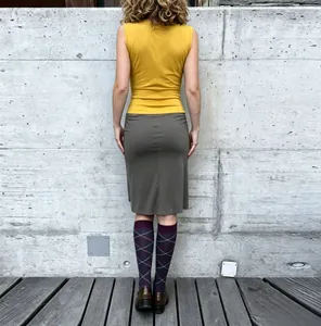 Back view of a slim fit yellow sleeveless tank top for women in modern urban style.