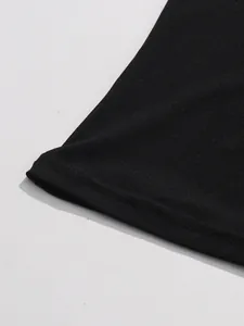 Primo piano di t-shirt nera che mostra la trama del tessuto e le couture dell'orlo