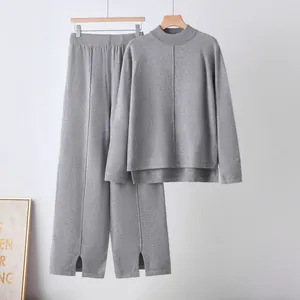 Grey knit two-piece set featuring long sleeve sweater and wide-leg pants with slits