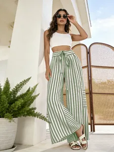 Focus on green and white vertical striped loose fit pants with high waist and tie detail