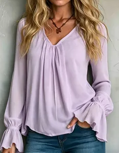 Close-up of an elegant lavender V-neck pleated blouse with stylish ruffled cuffs.
