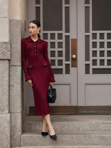 Elegant burgundy knitted midi dress with ruffle edges and contrast collar detail.