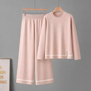 Elegant pink knitted two-piece set featuring long sleeve top and wide leg trousers.