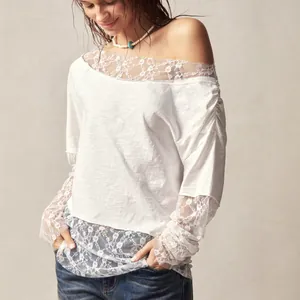 Detailed view of the elegant bohemian off-the-shoulder t-shirt with intricate lace cuffs.