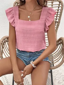 Macro detail of pink textured fabric on a square neck top with ruffle flutter sleeves