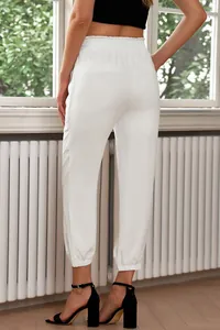 Back view of white high-waisted joggers showing elastic waist and fabric detail.