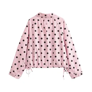 Back view of a casual pink polka dot jacket featuring a high collar and drawstring hem detail.
