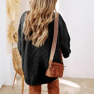 Back view of a chic black cable-knit sweater dress featuring an oversized and casual fit.