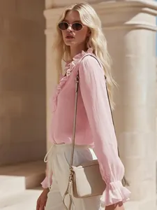 Detail view of pink French romantic linen shirt with elegant ruffles and V-neckline