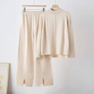 Elegant beige knit loungewear set featuring wide-leg slit pants and a loose sweater.
