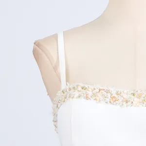 Close-up macro view of the white camisole neckline featuring intricate beaded and sequin details.