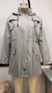Close-up of a gray medium-length hooded raincoat with striped lining and snap buttons.