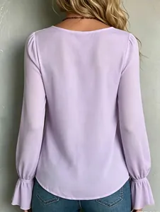 Detail back view of an elegant lavender long-sleeved blouse featuring ruffled pleated cuffs.