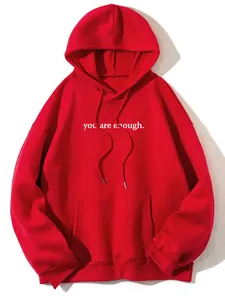 Detail view of a bright red fleece hoodie featuring white 'you are enough' chest print
