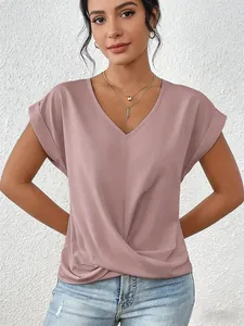 Detail view of a pink V-neck top featuring a unique twist hem and elegant cap sleeves.