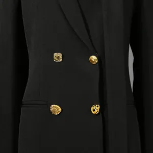 Vue détaillée d'un blazer noir pour femme avec des boutons dorés vintage ornés