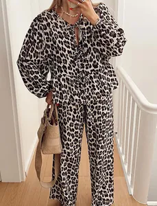 Close-up detail of leopard print two-piece set featuring lantern sleeves and lace-up top
