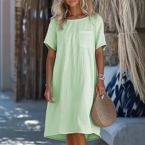 Detailopname van een lichtgroene casual jurk met korte mouwen en een borstzakje.