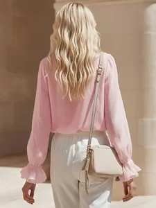 Back view detail of elegant pink linen-texture shirt featuring stylish ruffled cuffs