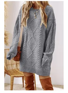 Detail view of a grey cable-knit sweater dress showing its oversized fit and cozy style