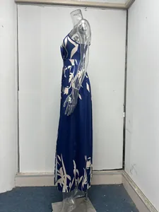 Side profile of a blue floral slanted shoulder maxi dress with a thigh-high slit.