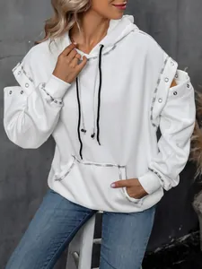 Detail view of white hooded sweatshirt with metal eyelet shoulder cutouts