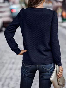 Back view of a stylish navy blue quilted sweatshirt featuring elegant puff sleeves.