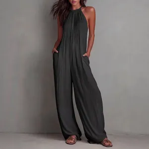Elegante tuta intera nera plissettata con scollo all'americana e gamba larga per vacanze
