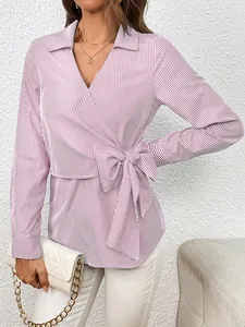 Detailed view of women purple vertical striped wrap blouse featuring a waist tie bow