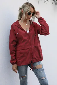 Women's burgundy lightweight hooded outdoor rain jacket with front zipper and pockets