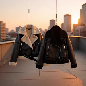 Detail of women's shearling aviator jackets in black and cream against sunset.