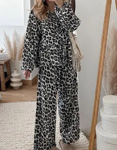 Full-body view of a stylish two-piece leopard print lounge set in a chic interior setting.
