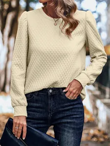 Detailed view of cream quilted puff sleeve sweatshirt with diamond pattern texture