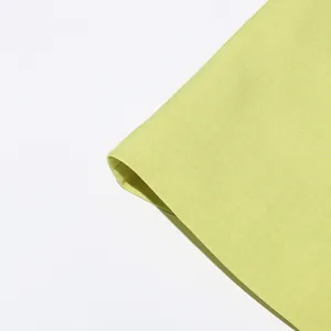 Macro detail of high-quality light green textured fabric for a casual women suit blazer
