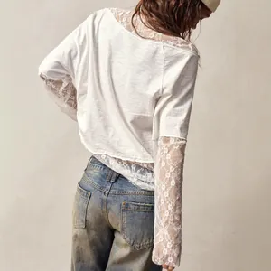 Detailed view of bohemian white t-shirt featuring elegant lace sleeves and slanted shoulder