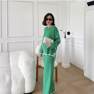Elegant green knit two-piece set with contrast white trim and wide-leg pants