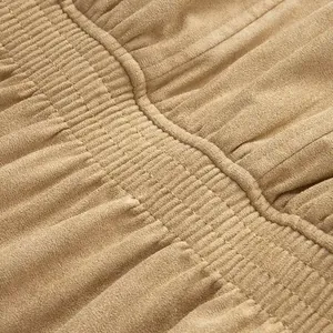 Close-up macro detail of the gathered smocked waist on a tan vintage faux suede jacket