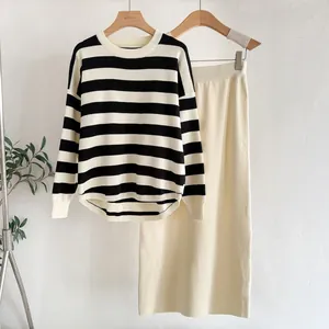 Close-up of striped knit texture on the sweater and coordinating cream midi skirt