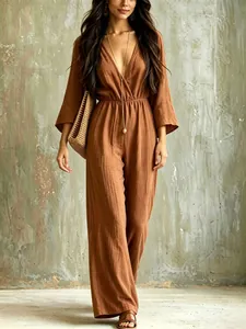 Elegant bohemian V-neck brown jumpsuit with wide legs and long sleeves shown in full.