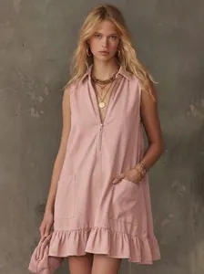 Sleeveless pink A-line dress featuring a half-zip V-neck and ruffled hemline detail