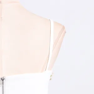 Close-up detail of white camisole top featuring thin shoulder strap and back zipper closure