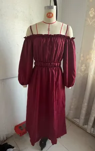 Close-up of maroon off-the-shoulder maxi dress with puff sleeves and pleated waist